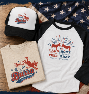 American-themed t-shirt, cap, and shirt with patriotic designs on a wooden surface.